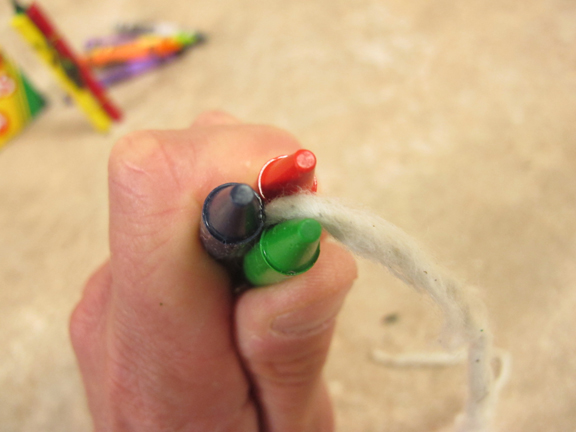 Cotton fiber wick in middle of three paperless crayons.